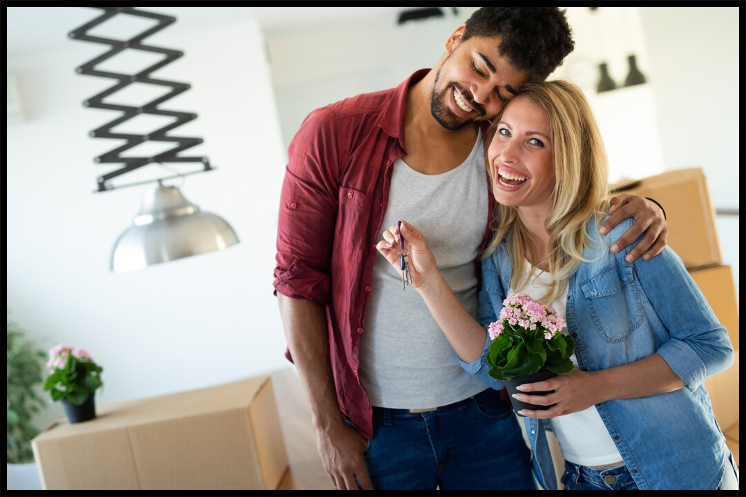 young couple smiling about the roofing tips for new homeowners