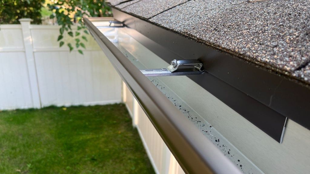 A brand new gutter installed near the roof of a home.